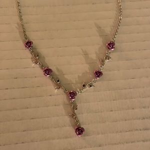 Y necklace with purple flowers and stones.